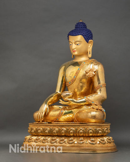Left profile of Shakyamuni Buddha statue, seated on double-layered lotus, detailed ceremonial robe