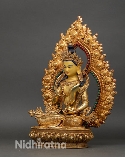 left profile of vajrasattva statue with turquoise and coral inlaid torana and gold finish