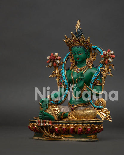Left side of Green Tara Statue — Lalitasana pose, extended foot, coral gem lotus and gold garments