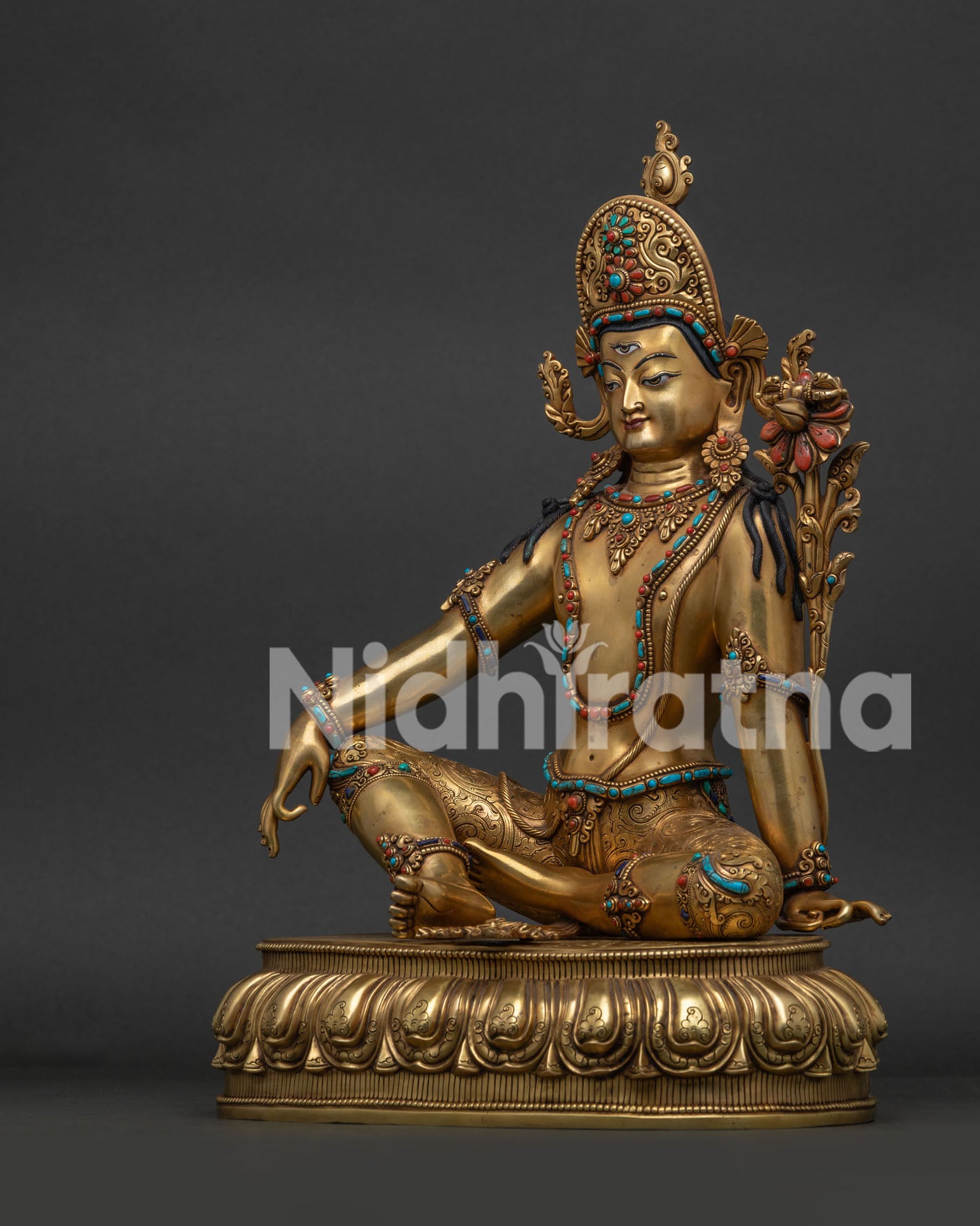 Left side profile of gold-gilded Sakra Indra copper sculpture on lotus base