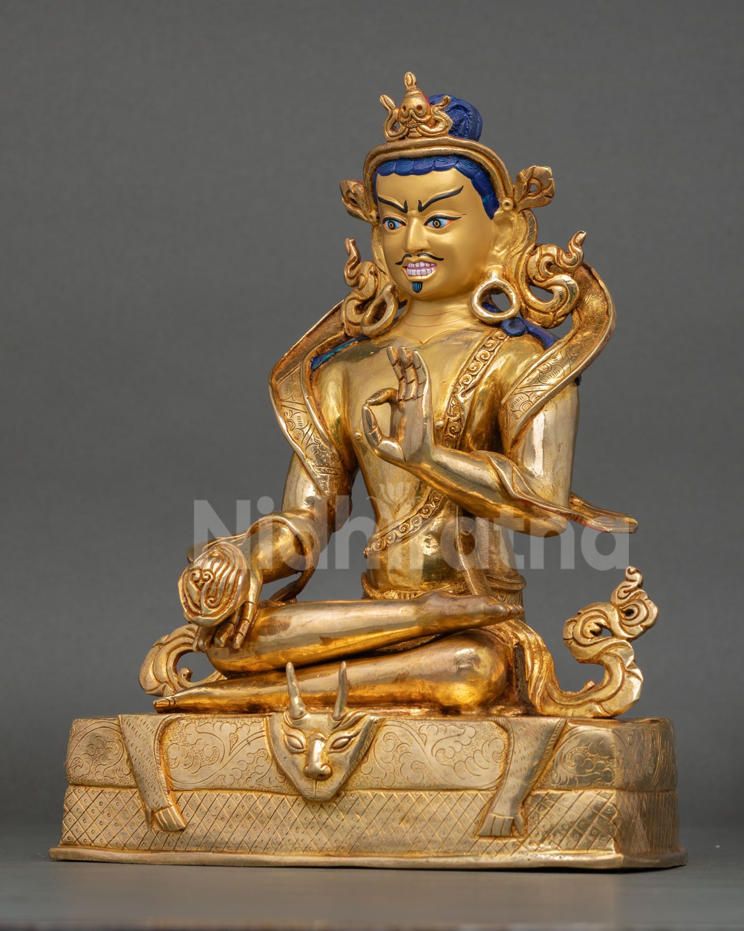 left side profile of tilopa meditation statue with intricate floral carvings and pedestal