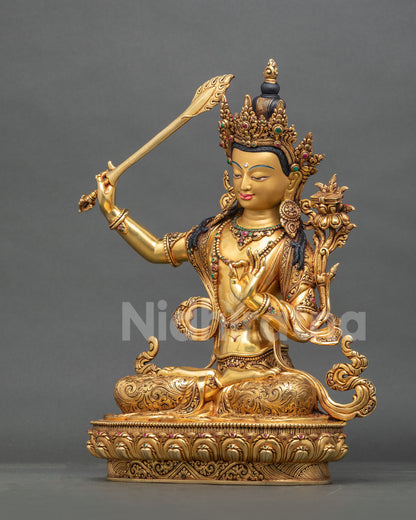 Left side profile view of Manjushri statue showing flaming sword and lotus pedestal.