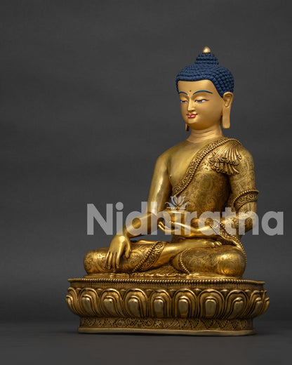 Left side profile view of copper Shakyamuni Buddha statue holding sacred alms bowl