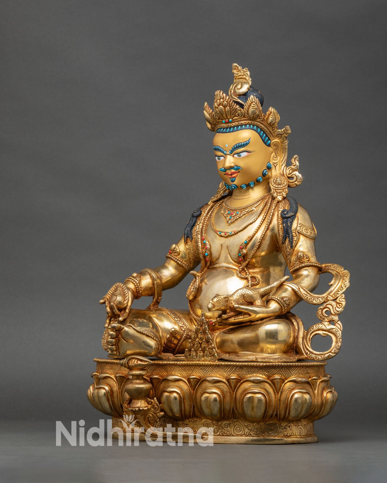 Left side view of Dzambhala statue, gold fire-gilded, intricate jewelry and lotus seat