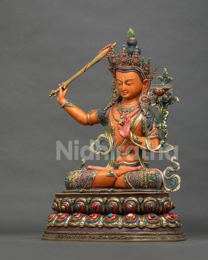 Left side view of handmade copper Manjushri Buddha Statue from Nepal