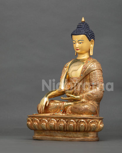 Left side view of 24K gold Shakyamuni Buddha meditation sculpture resting on a lotus pedestal.