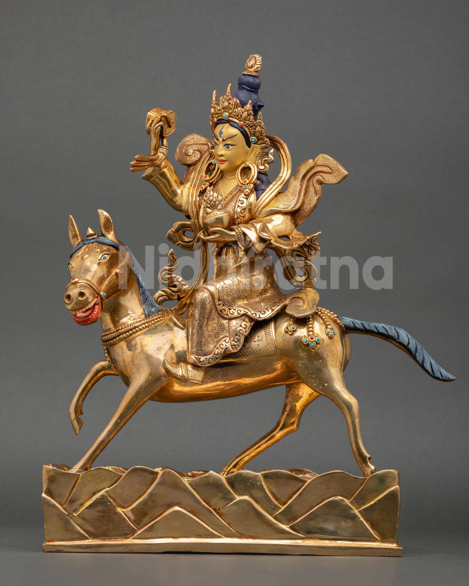 left side view of achi chokyi drolma sculpture with painted horse mane and ornaments