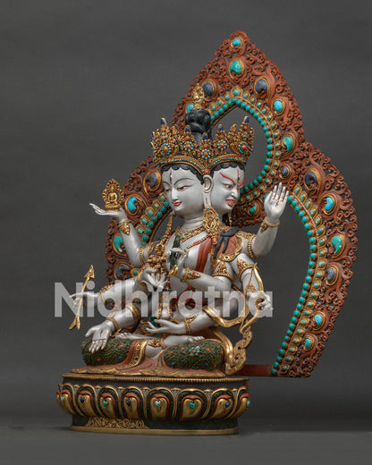 left side view of acrylic painted namgyalma statue with floral halo and gold gilded details