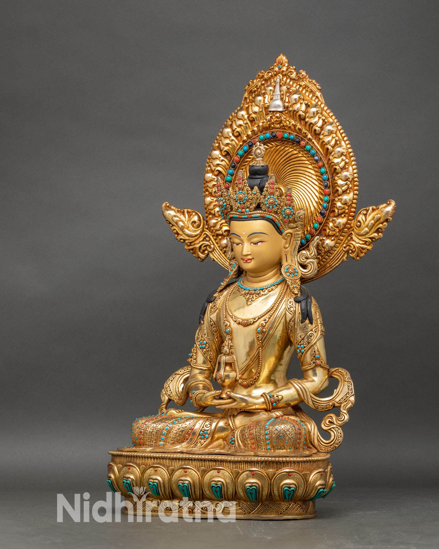 Left side view of Amitayus Buddha statue with lotus base and jeweled ornaments