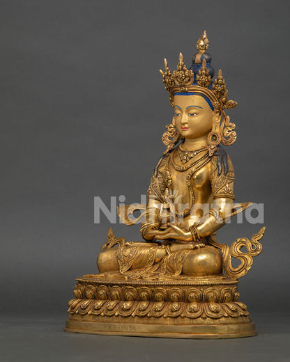 left side view of amitayus buddhist sculpture with copper and gold gilded details