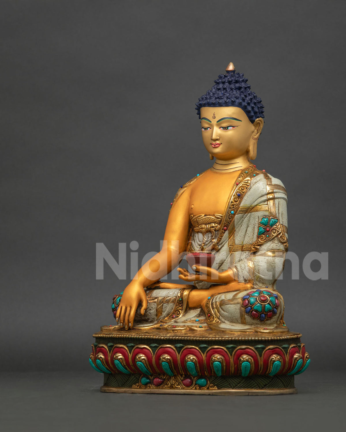 Left side view of Buddha statue with alms bowl and gold-trimmed acrylic robe