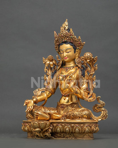Left side view of Buddhist Green Tara statue from Nepal with lotus flowers and gold gilding