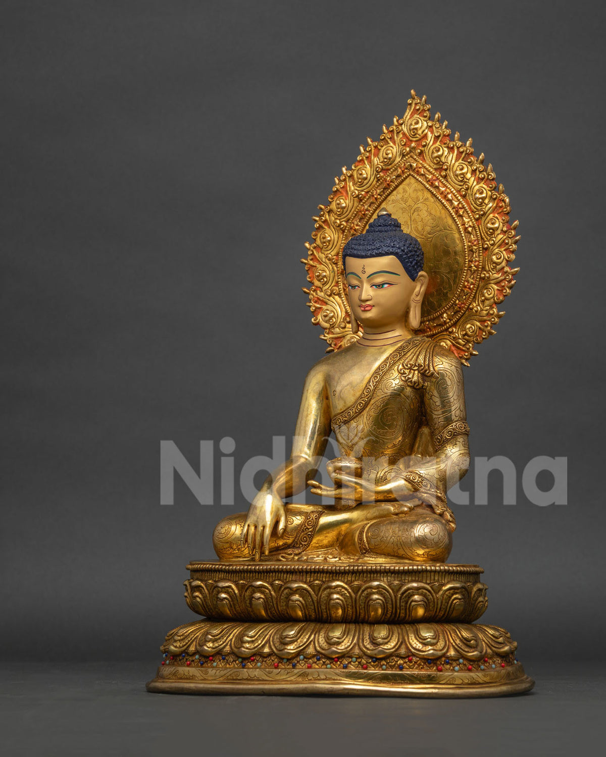 Left side view of copper Buddha sculpture, earth-touching mudra, double lotus seat detail