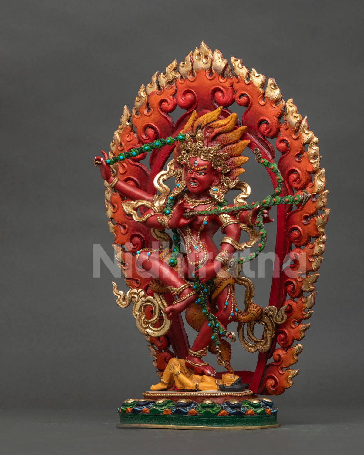 Left side view of Dancing Kurukulla copper statue with intricate Nepalese details