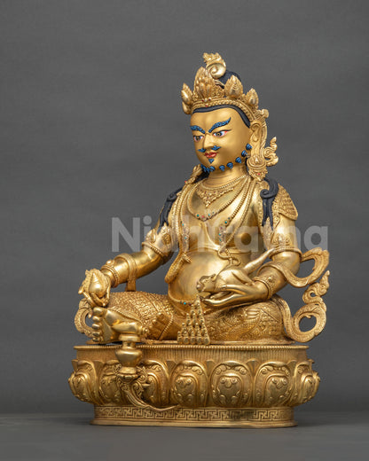 Left side view of Dzambhala copper statue with jewel-spitting mongoose, symbol of abundance