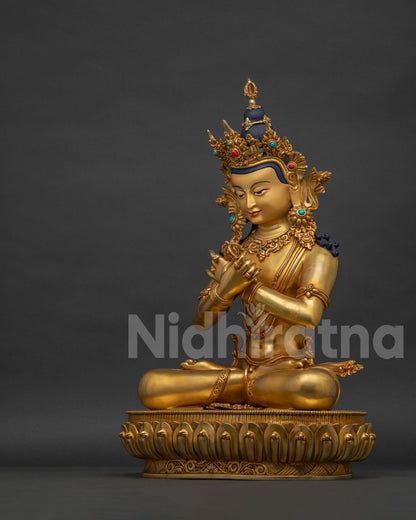 Left side view of fire-gilded Vajradhara statue with vajra and bell held at heart