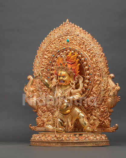 Left side view of fire-gilded Vajrapani statue with flaming hair and lotus base, Nepalese craftsmanship