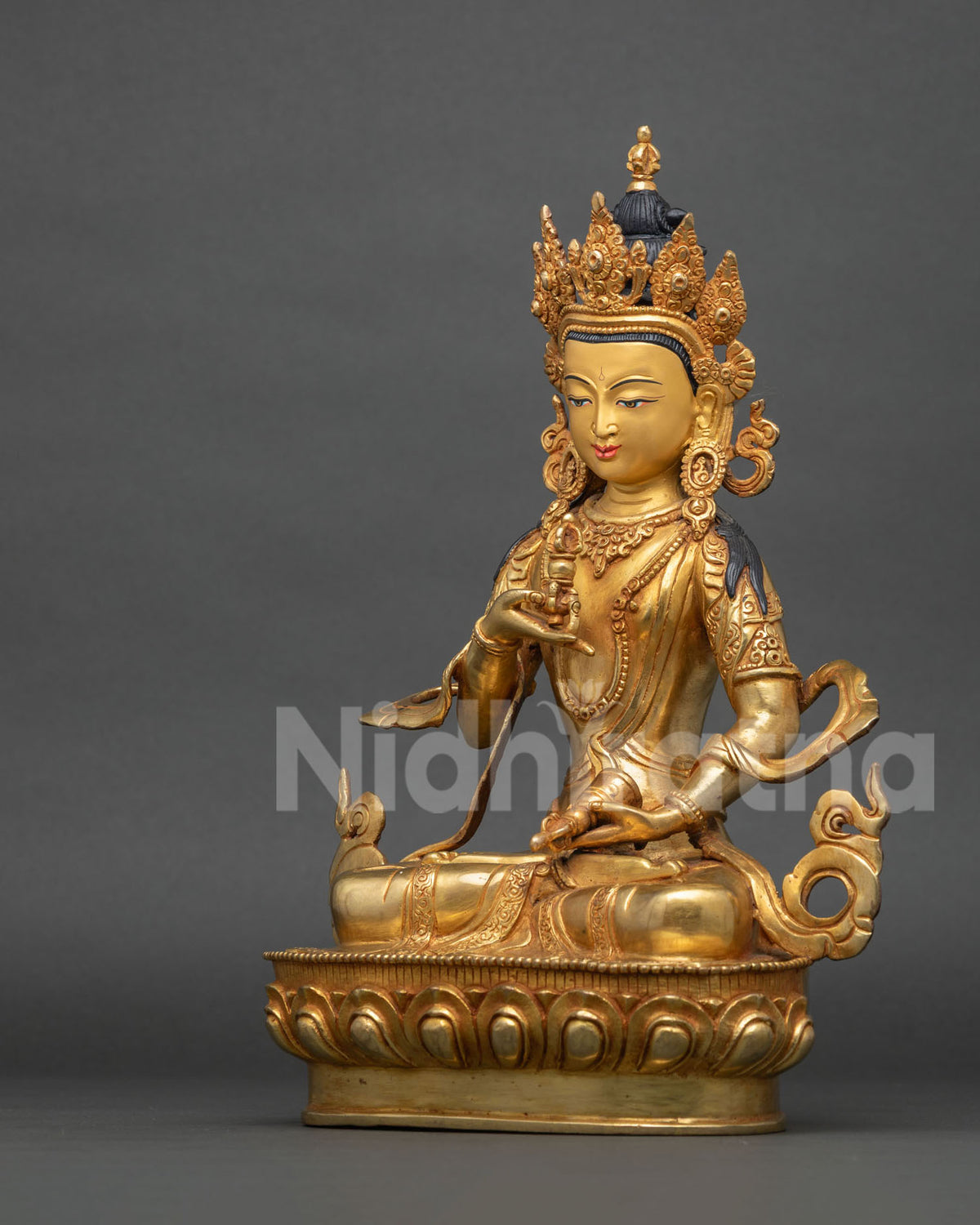 Left side view of fire-gilded Vajrasattva statue with dorje and ghanta, handcrafted Nepalese figurine