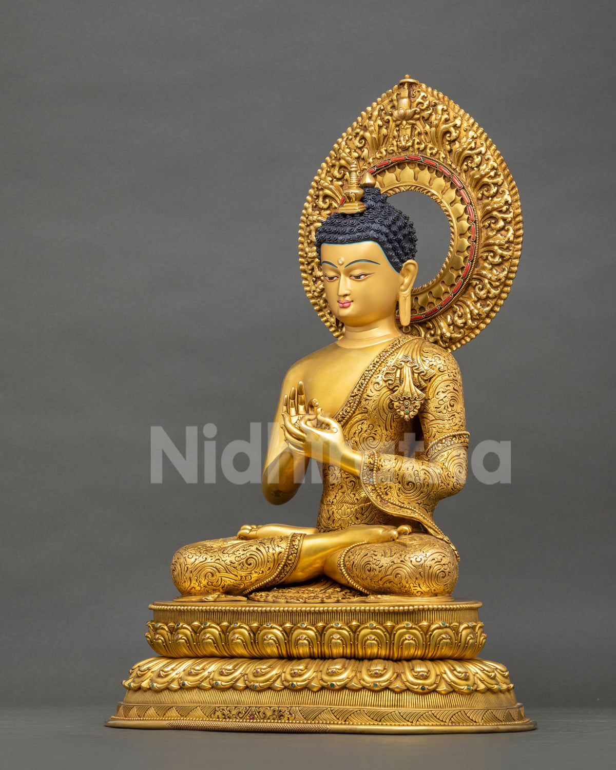 Left side view of Future Buddha Maitreya statue with fire-gilded robe, inlaid halo and lotus base