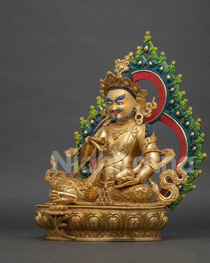 Left side view of gold Dzambhala copper statue holding jewel-spitting mongoose