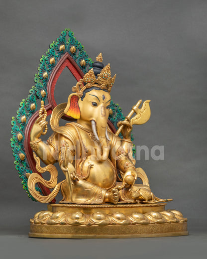 Left side view of gold fire-gilded Four-armed Ganesh statue seated on a lotus pedestal with halo