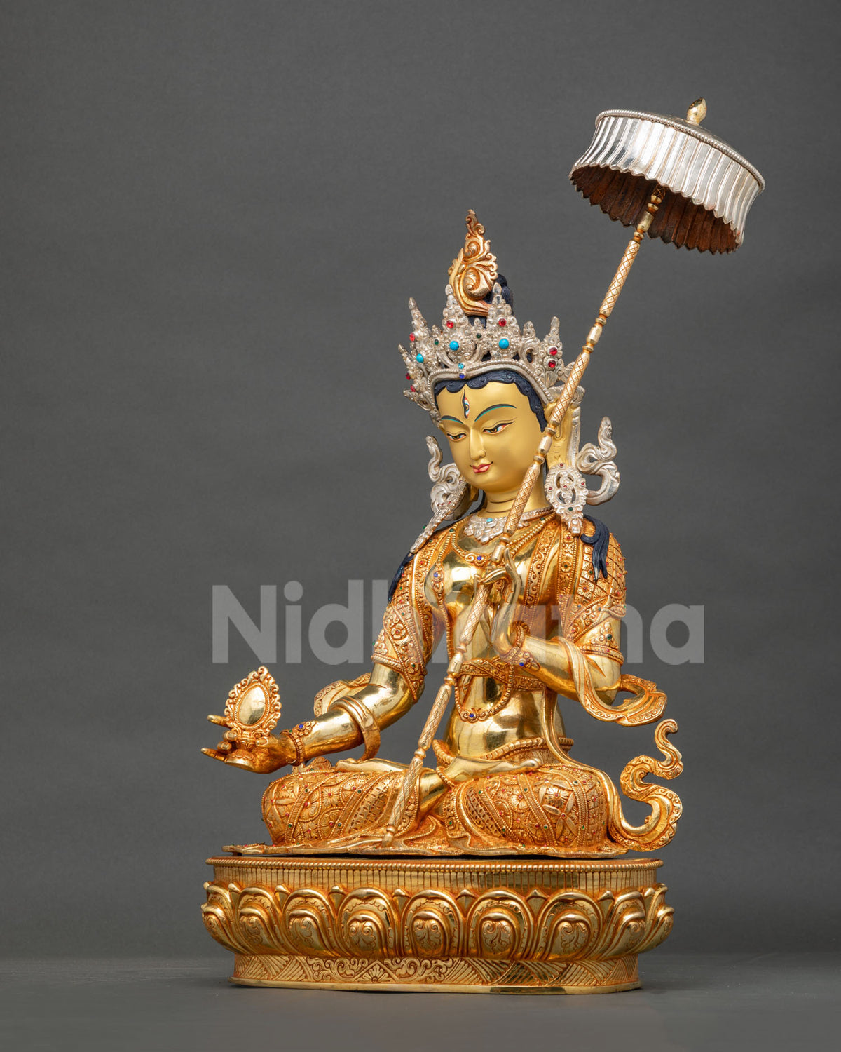 Left side view of gold-gilded Dukar Statue holding sacred mirror, White Parasol Goddess from Nepal