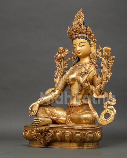 Left-side view of Green Tara Buddhist sculpture displaying royal ease posture and ornaments