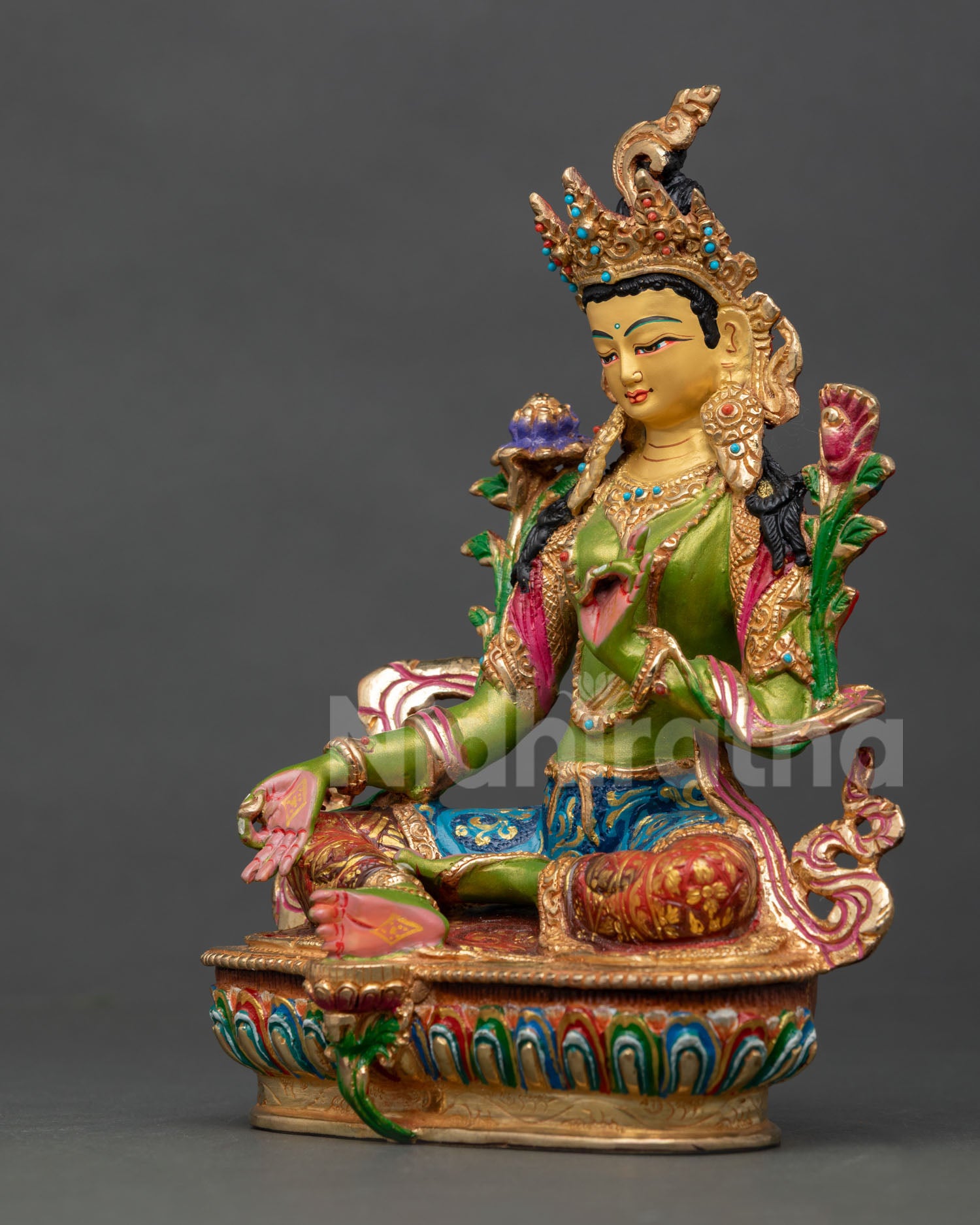left side view of green tara buddhist statue with copper craftsmanship and lotus seat