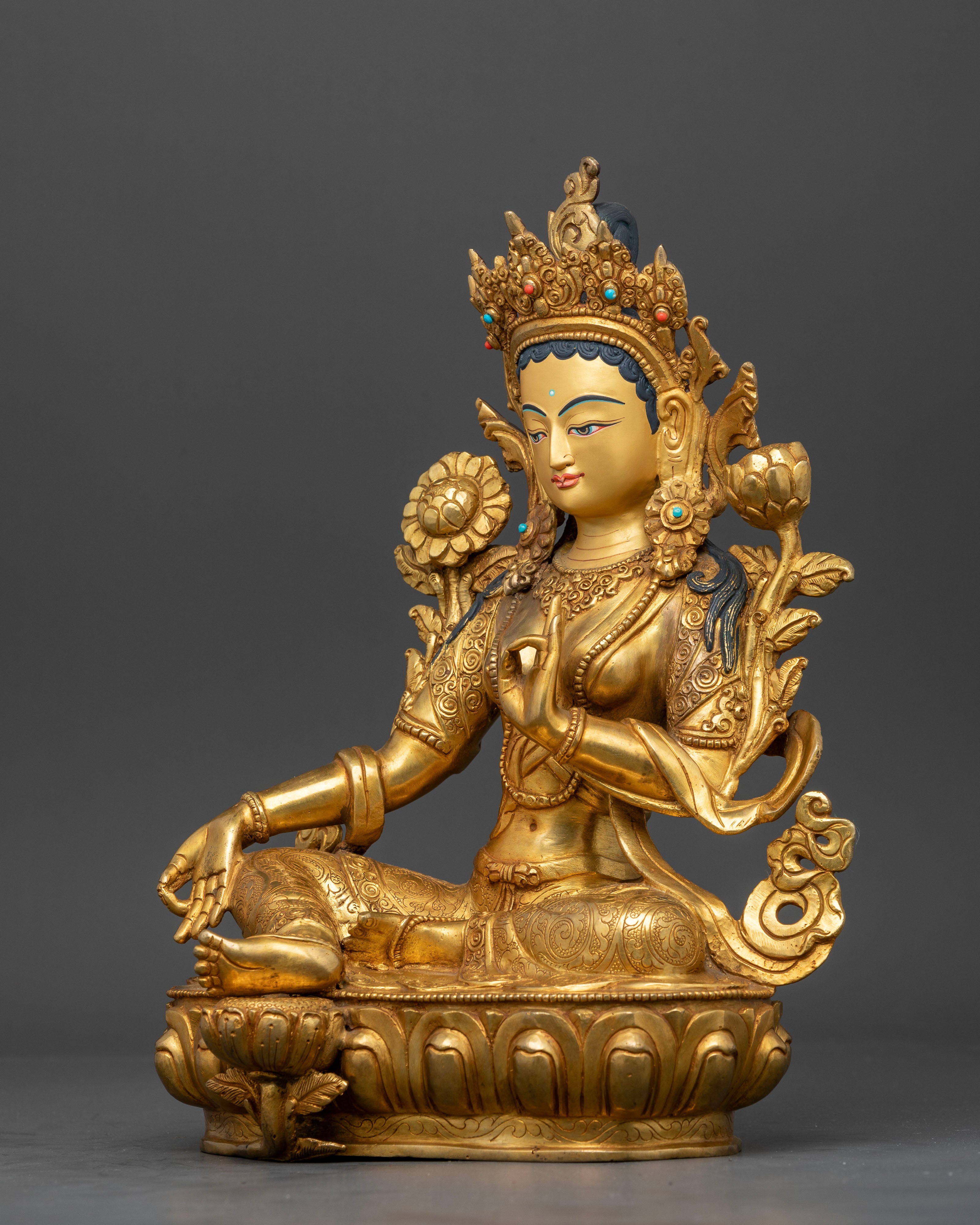 Left side view of Green Tara Statue featuring handcrafted ornaments and sacred iconography