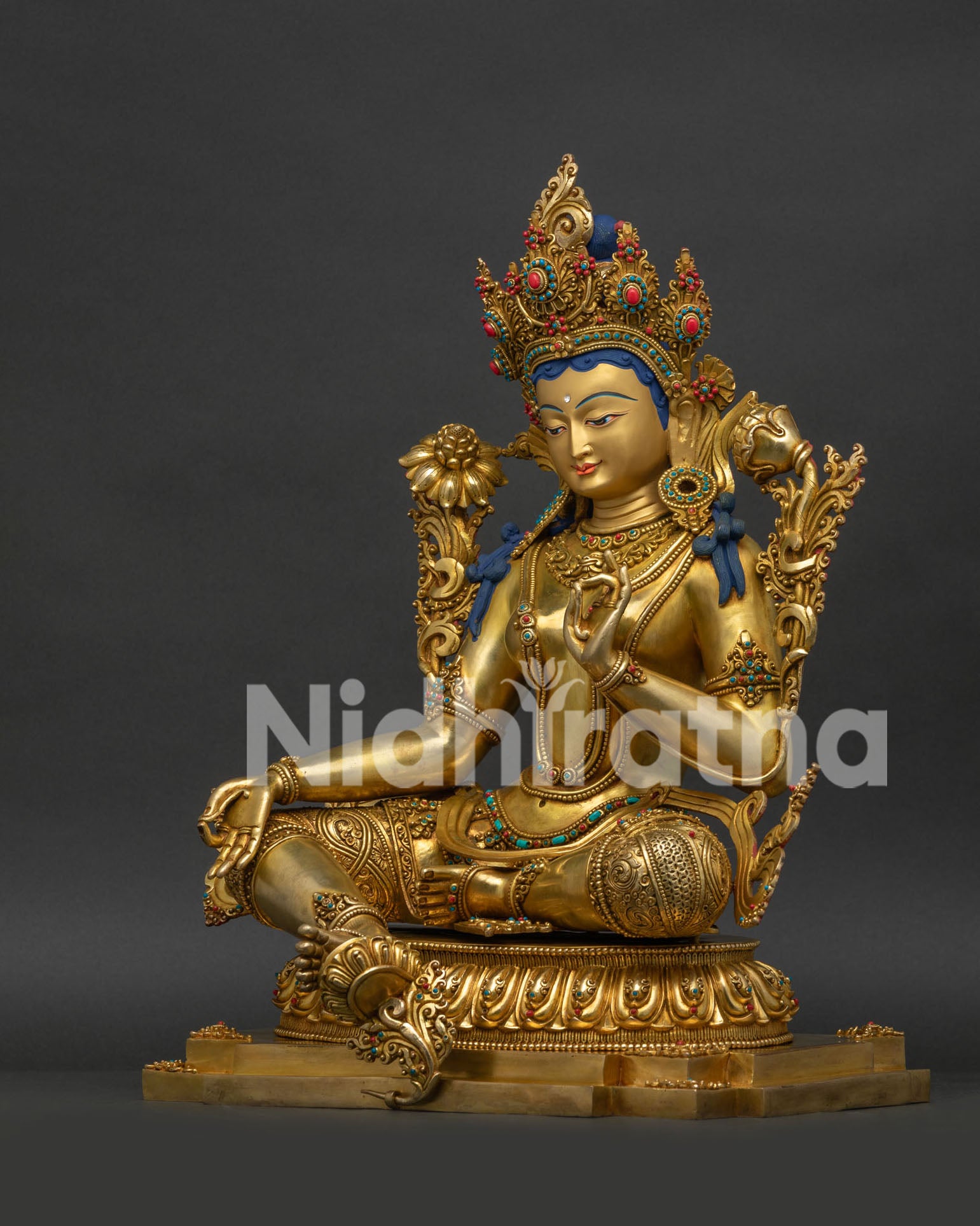 Left Side View of Green Tara Statue Featuring Intricate Jewelry and Lotus Pedestal Details