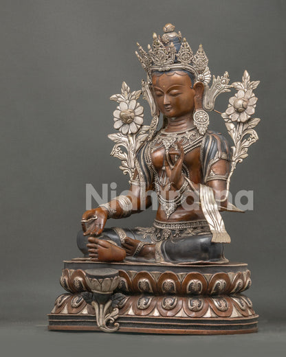 Left side view of Green Tara Statue featuring lotus throne and handcrafted oxidized copper design