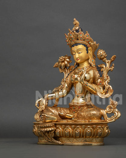 Left side view of Green Tara statue, handcrafted in Nepal with Abhaya Mudra and utpala flower