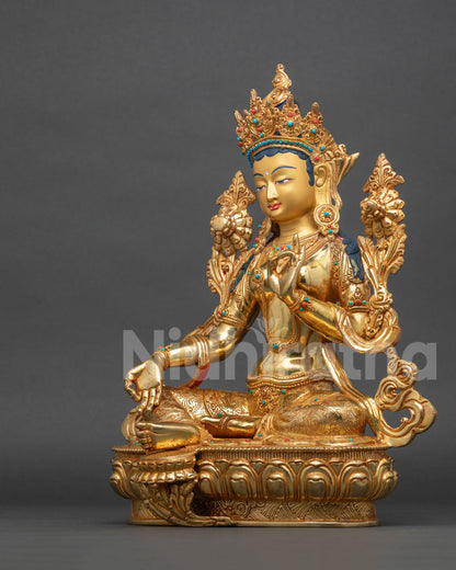 Left side view of Green Tara statue holding an utpala flower, lost-wax cast copper with 24K gold gilding