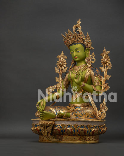 Left side view of Green Tara statue showing gold gilding lotus flowers and ornate jewelry