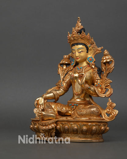 Left side view of Green Tara statue utpala flower varada abhaya mudra