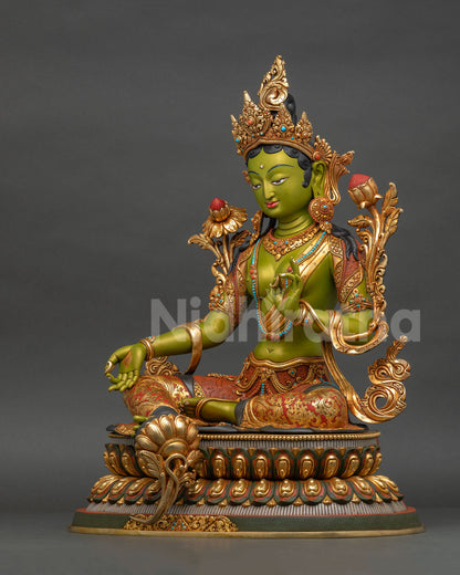 Left side view of Green Tara statue with repoussé garment details, copper casting, and gold gilded accents