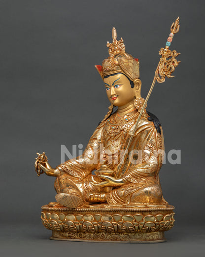 left side view of guru rinpoche padmasambhava statue with gold gilded details