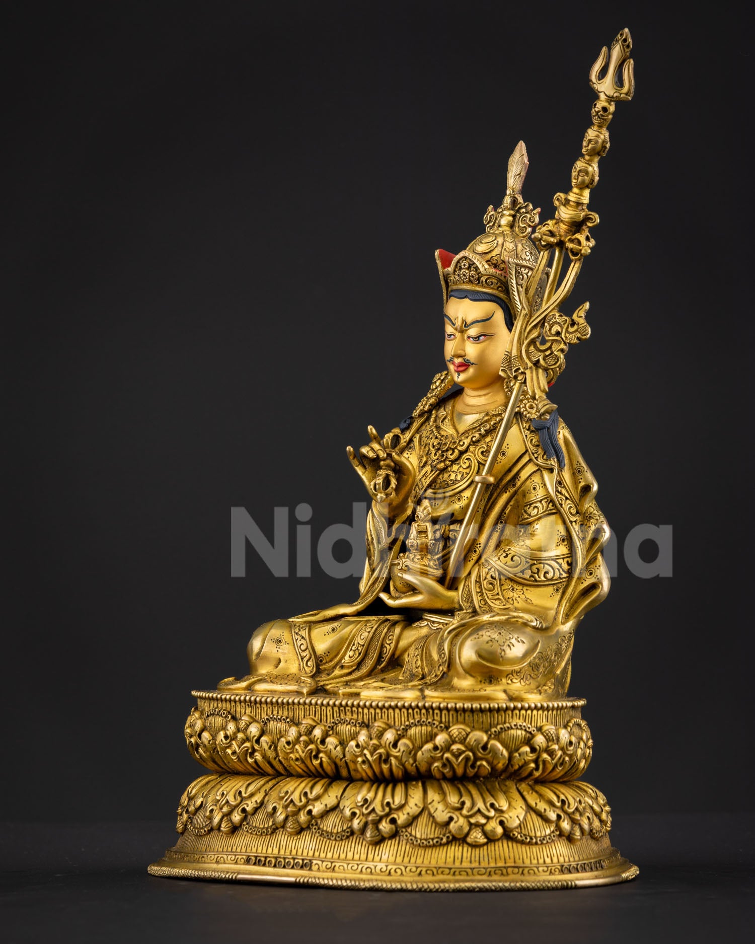 Left side view of Guru Tsokye Dorje Himalayan statue with khatvanga staff detail