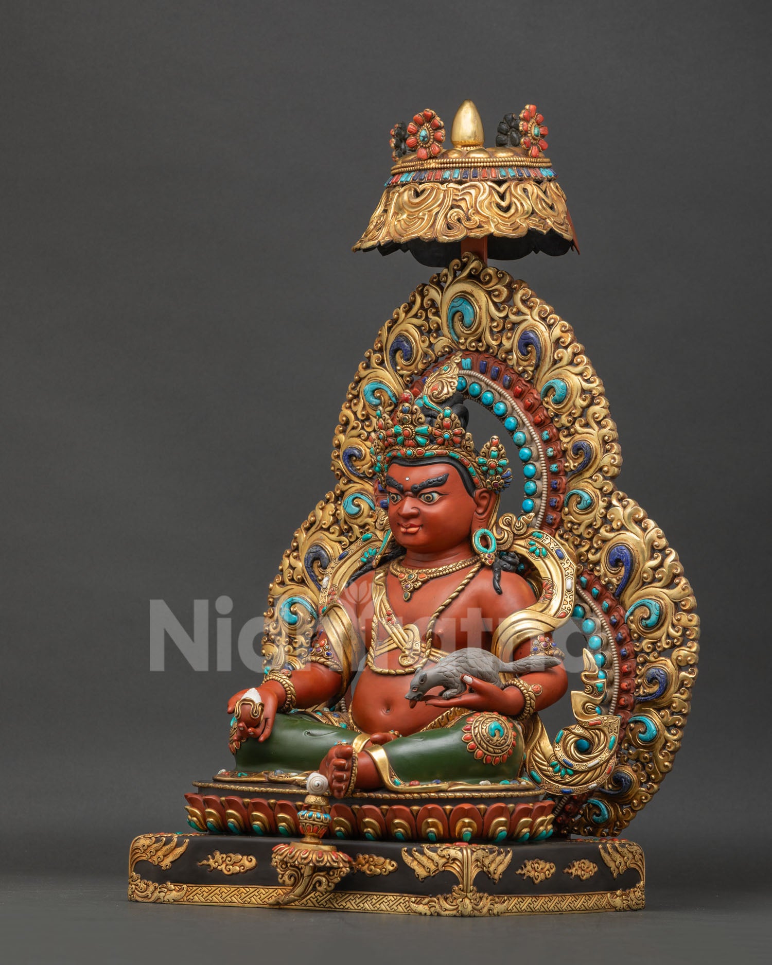 Left side view of handcrafted Dzambhala Statue with flaming aureole and jeweled parasol