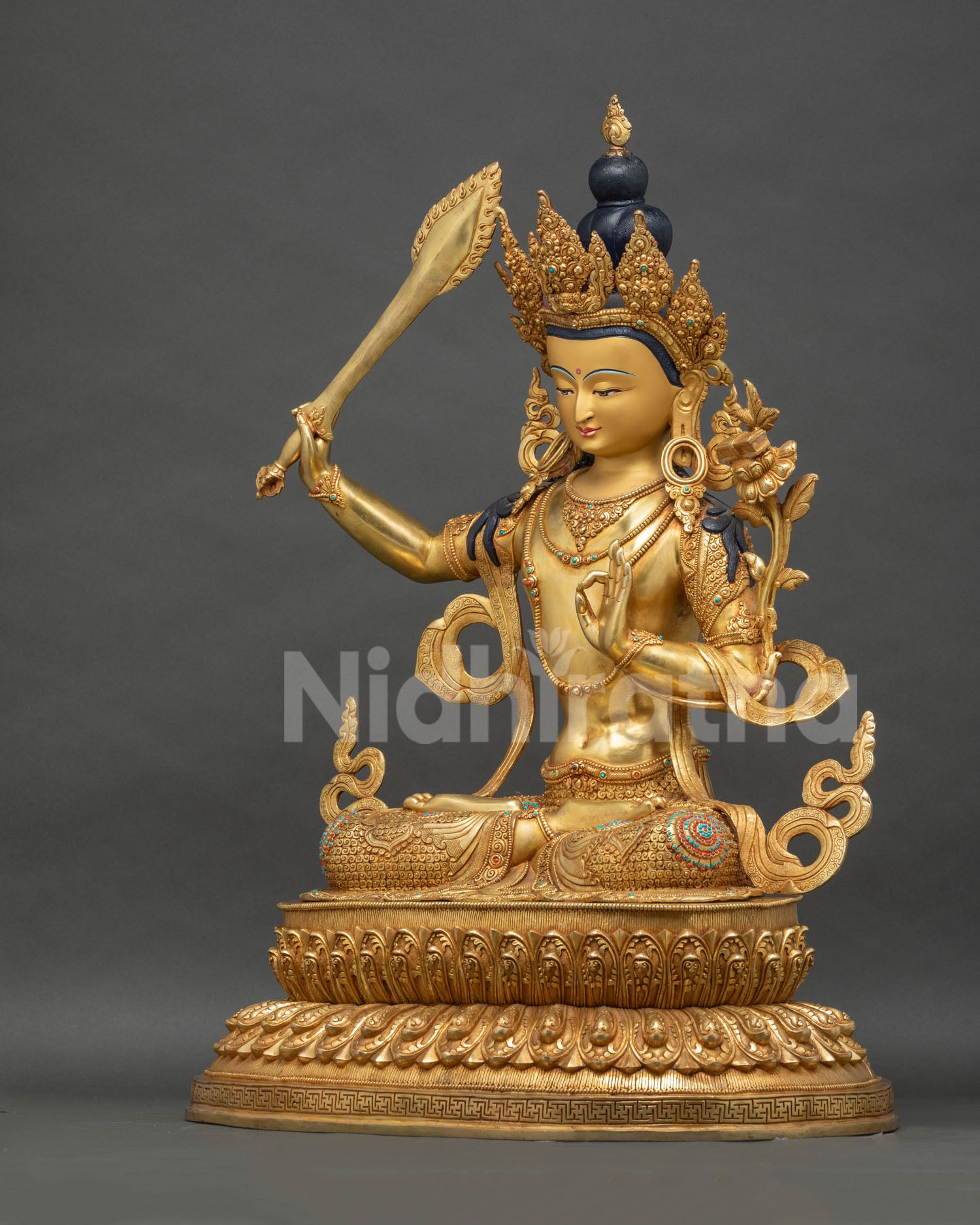 Left side view of handcrafted Manjushri statue with lotus pedestal, Nepal