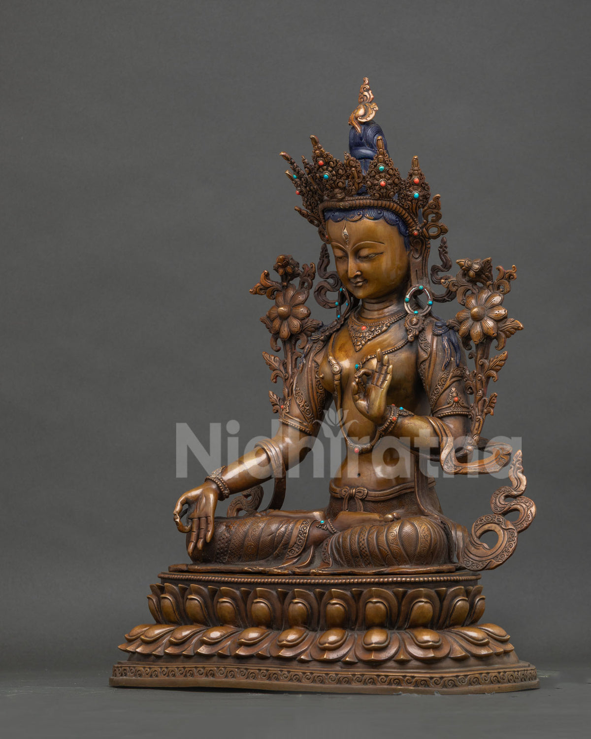 Left side view of handcrafted oxidized copper White Tara Buddhist statue