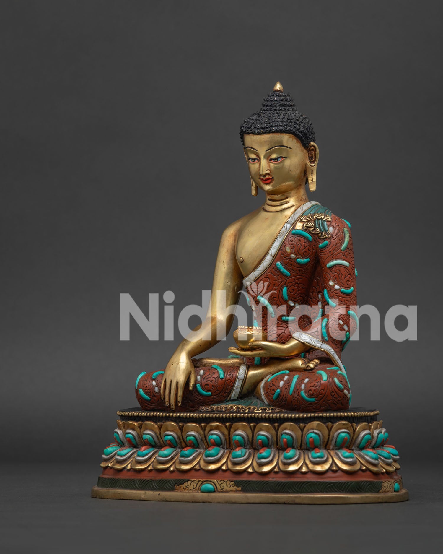 Left side view of handcrafted Shakyamuni Buddha statue with crimson robe turquoise inlays lotus throne