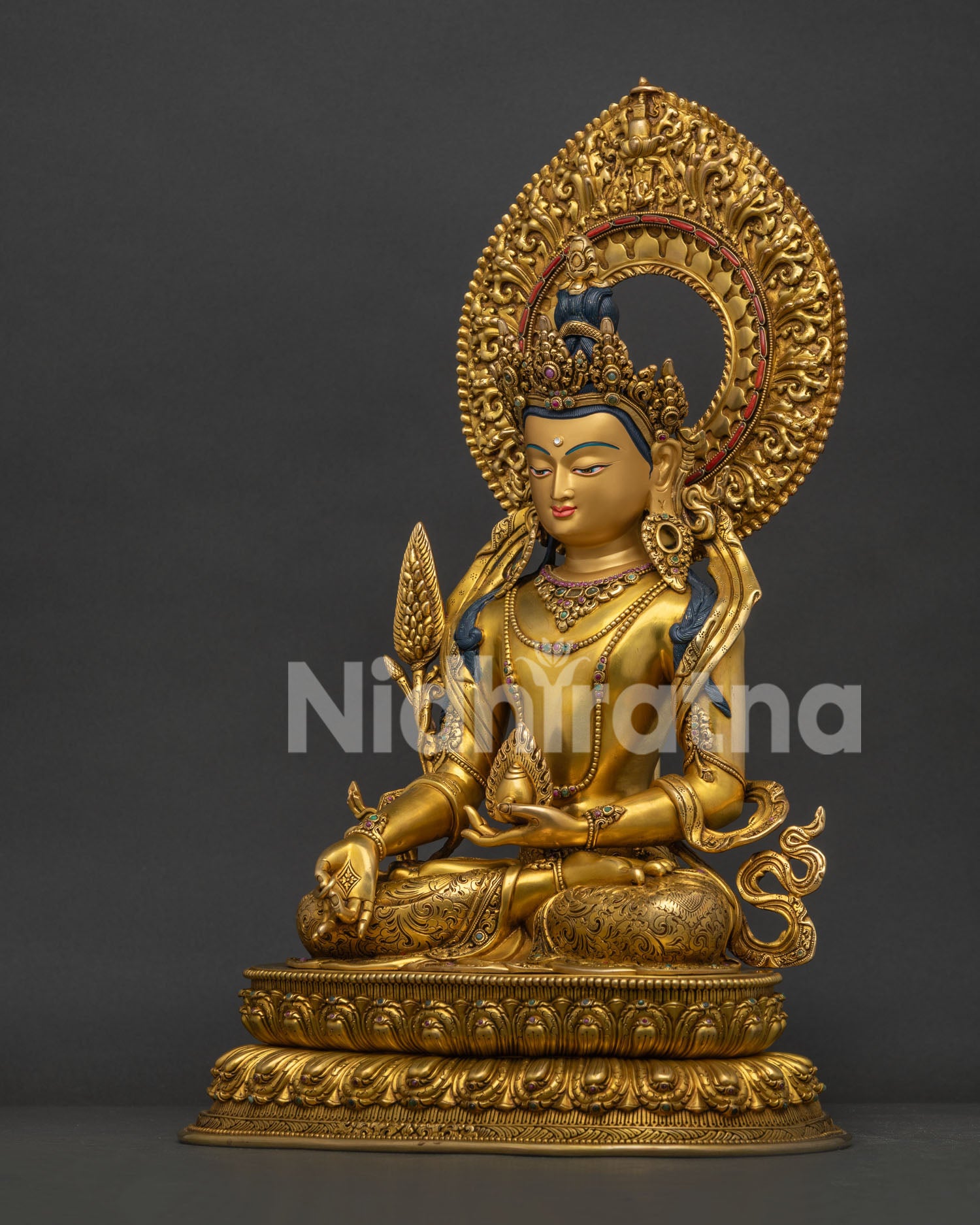 Left side view of Ksitigarbha Bodhisattva statue showing robes and gold gilding