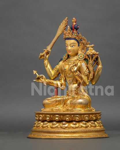 Left side view of Maha Manjushri copper statue with Prajnaparamita Sutra, bow and arrow, and gold gilding
