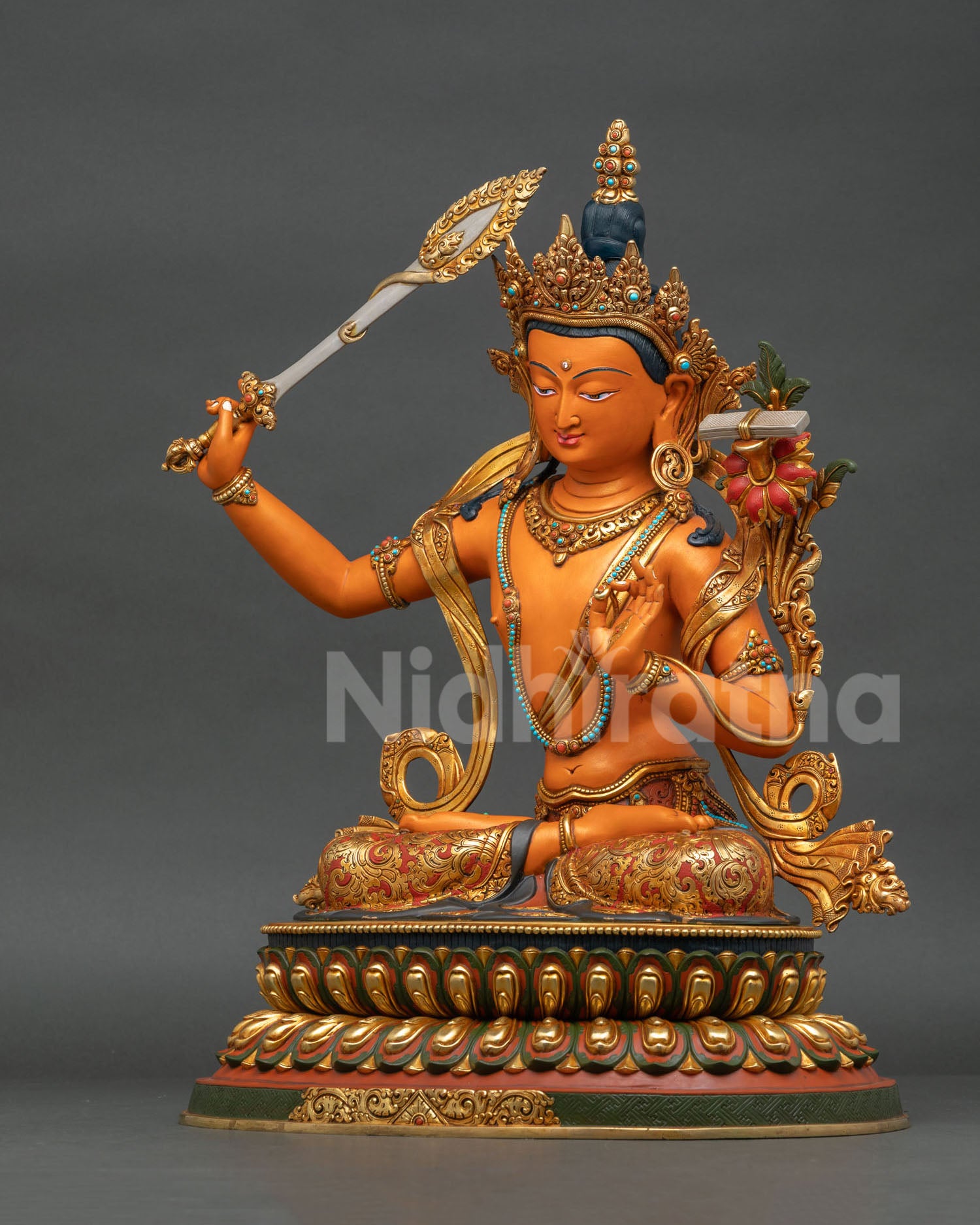 Left side view of Manjushri Statue highlighting lotus stem, scripture, and gold-gilded artistry