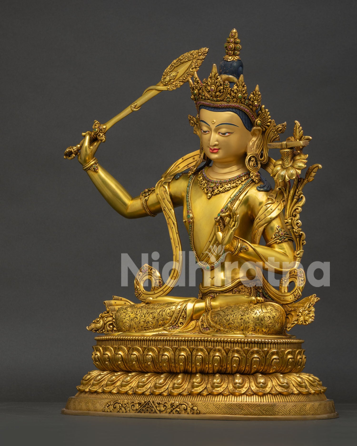 Right side view of Tibetan Manjushri statue holding flaming sword