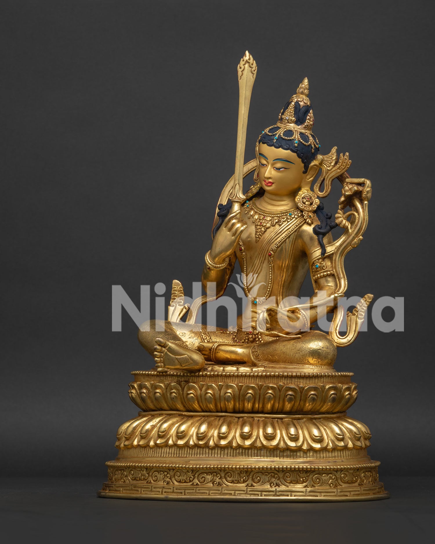 Left side view of Manjushri Statue holding utpala lotus and Prajnaparamita scripture