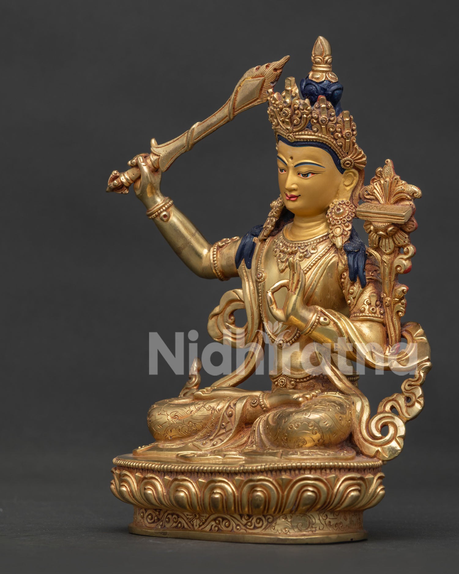 Left side view of Manjushri Statue holding utpala lotus with Prajnaparamita scripture