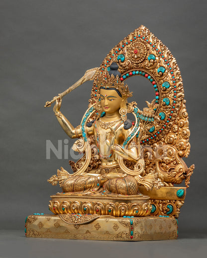 Left side view of Manjushri statue in gold fire-gilded copper with utpala flower and ornate halo