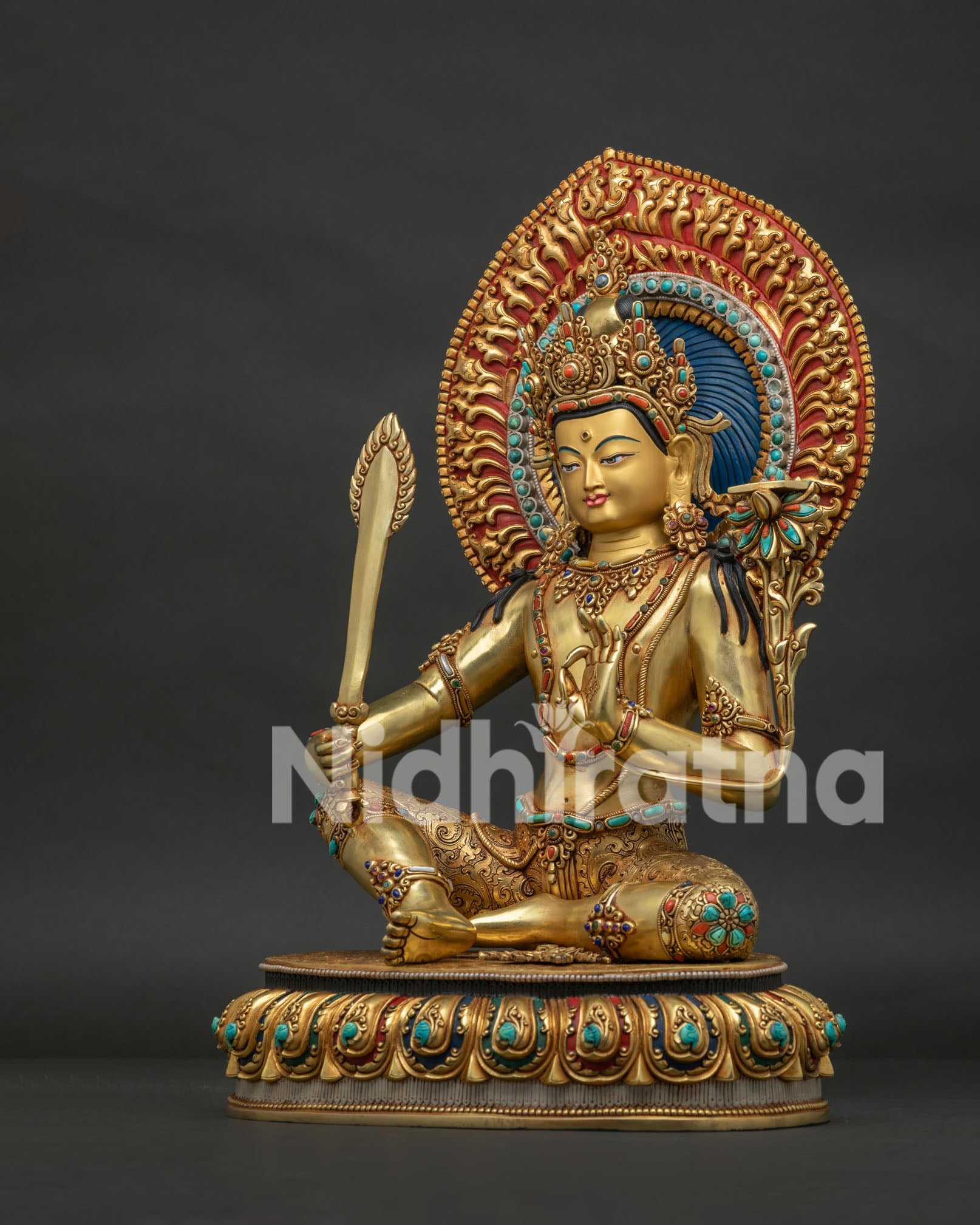 Left side view of Manjushri statue — utpala lotus stem and Prajnaparamita scripture detail
